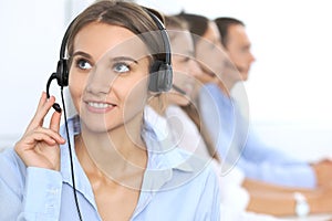 Call center operator in headset while consulting client. Telemarketing or phone sales. Customer service and business