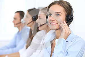 Call center operator in headset while consulting client. Telemarketing or phone sales. Customer service and business