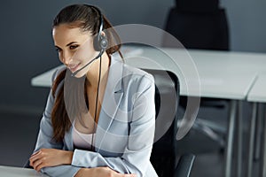 Call Center Operator Sitting Infront of Her Computer photo