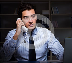 Call center operator talking to customer during night shift