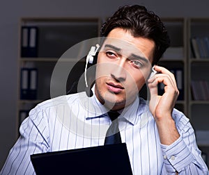 Call center operator talking to customer during night shift