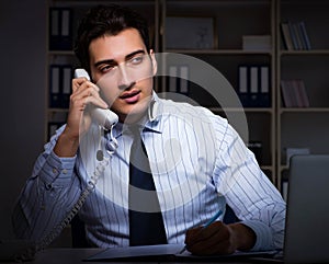 Call center operator talking to customer during night shift