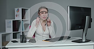 Call center operator is tired of talking to people asking stupid questions. Young customer service representative at