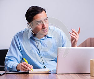 Call center operator working at his desk