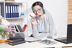 Call Center operator works for computer headphones