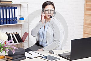 Call Center operator works for computer headphones