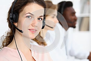 Call center operator.Young beautiful brunette woman in headset. Business concept
