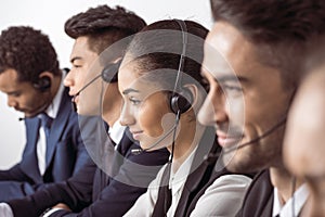 Call center operators in headsets working together