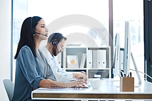 Call center, people and team in customer service, support or telemarketing on computer at the office. Woman and man