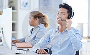 Call center, smile and asian man in office for customer support, advice and friendly service. happy, telemarketing and