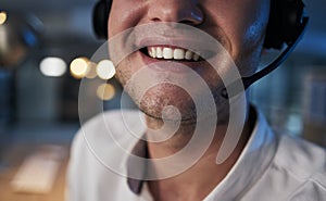 Call center, smile and mouth of a worker in telemarketing, support and crm business in a dark office. Ecommerce, contact