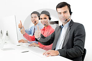 Call center or telemarketer team giving thumbs up