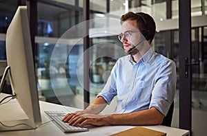 Call center, web communication and businessman working as consultant as telemarketing company in dark office. Customer