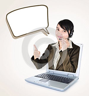 Call center woman with headset showing thumbs up with laptop