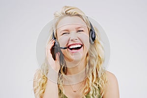 Call center, woman and laugh in studio portrait with headset, smile and excited for tech support by backdrop. Funny