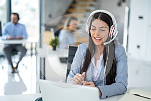 Call center worker communicating with client trying to sell company products during online meeting at office