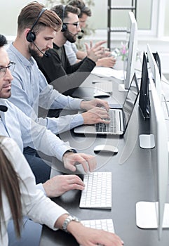 Call centre employees working on computers with their headset