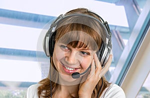 Call centre operator with headset at workplace in call center
