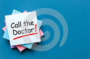 Call the Doctor - note pinned at corkboard. Concept of healthy life 911