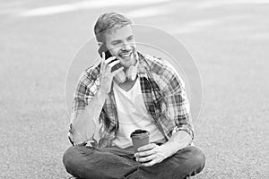 Call friend. Wellbeing and health. Having coffee break. Man sit on ground while drinking coffee. Relax and recharge