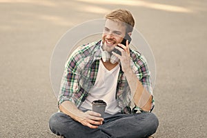 Call friend. Wellbeing and health. Having coffee break. Man sit on ground while drinking coffee. Relax and recharge
