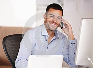 Call me if youre looking for someone with a good work ethic. Portrait of a smiling young man sitting at his desk and