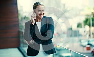 Call me and lets talk business. Portrait of a mature businesswoman standing outside on the balcony of an office and