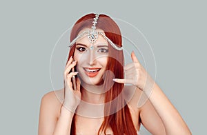 Call me on my mobile. Happy woman smiling talking at mobile phone smiling with teeth and showing call me sign gesture with hand