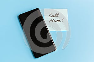 Call mom message near the telephone - the message asking or reminding you to call your mom. Parenting concept