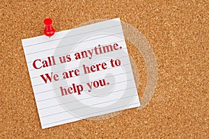 Call us anytime on lined rule paper on corkboard