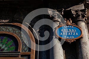 Calle Arenal. Areatza Kalea. Ornate gold and blue street name plaque