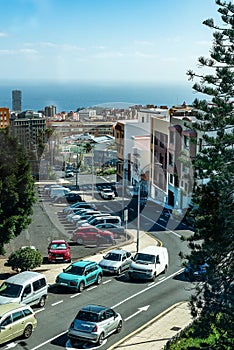 Calle de ciudad cerca del mar con automoviles circulando en Santa Cruz de Tenerife. Islas Canarias photo