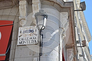 Calle de La Montera Sign and Royal Lamp Head in the streets of Madrid, Spain