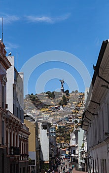 Calle en el centro histÃÂ³rico de Quito con vista a la Virgen del Panecillo photo