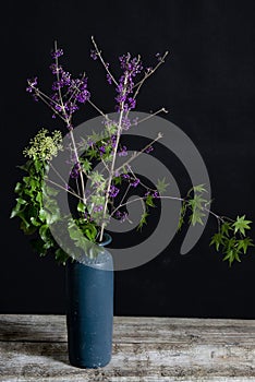 Callicarpa and Hedera helix in blue vase.