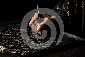 calligrapher in motion, writing phrase or quote on black background