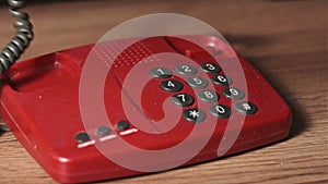 Calling 911 On an Old Retro Red Telephone with Dial Buttons