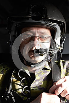 Calling air to ground.... Portrait of a pilot in his aircraft wearing a helmet with a communication device.