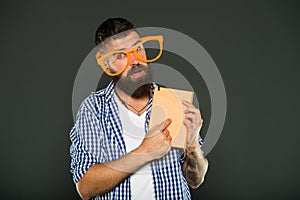 Calling attention to his manual. Book nerd wearing fancy glasses. Bearded man in party glasses with lesson book. Study