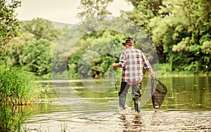 Calling Fly-Fishing a hobby. fisherman with fishing rod. retired bearded fisher. Trout bait. hobby and sport activity