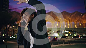 Calling man peeping taxi at night town closeup. Happy businessman waving hand