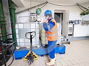 Calling worker. Industrial engineer using phone in industry room