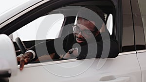 Calm African man customer buyer client in suit holding hands on steering wheel.