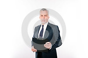 Calm aged focused man working with clipboard
