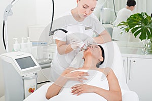 Calm asian woman taking procedure at spa
