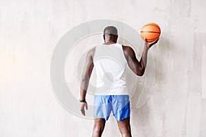 Calm athletic guy playing with ball