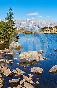 Calm autumn Alps mountain lake with clear transparent water and reflections. Spiegelsee or Mirror Lake, Reiteralm, Steiermark,