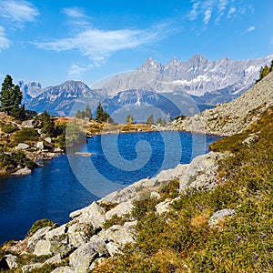 Calm autumn Alps mountain lake with clear transparent water and reflections. Spiegelsee or Mirror Lake, Reiteralm, Steiermark,