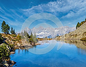 Calm autumn Alps mountain lake with clear transparent water and reflections. Spiegelsee or Mirror Lake, Reiteralm, Steiermark,