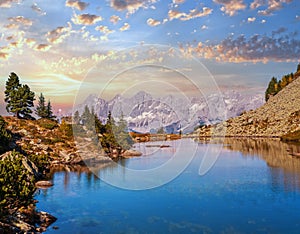 Calm autumn Alps mountain lake with clear transparent water and reflections. Spiegelsee or Mirror Lake, Reiteralm, Steiermark,